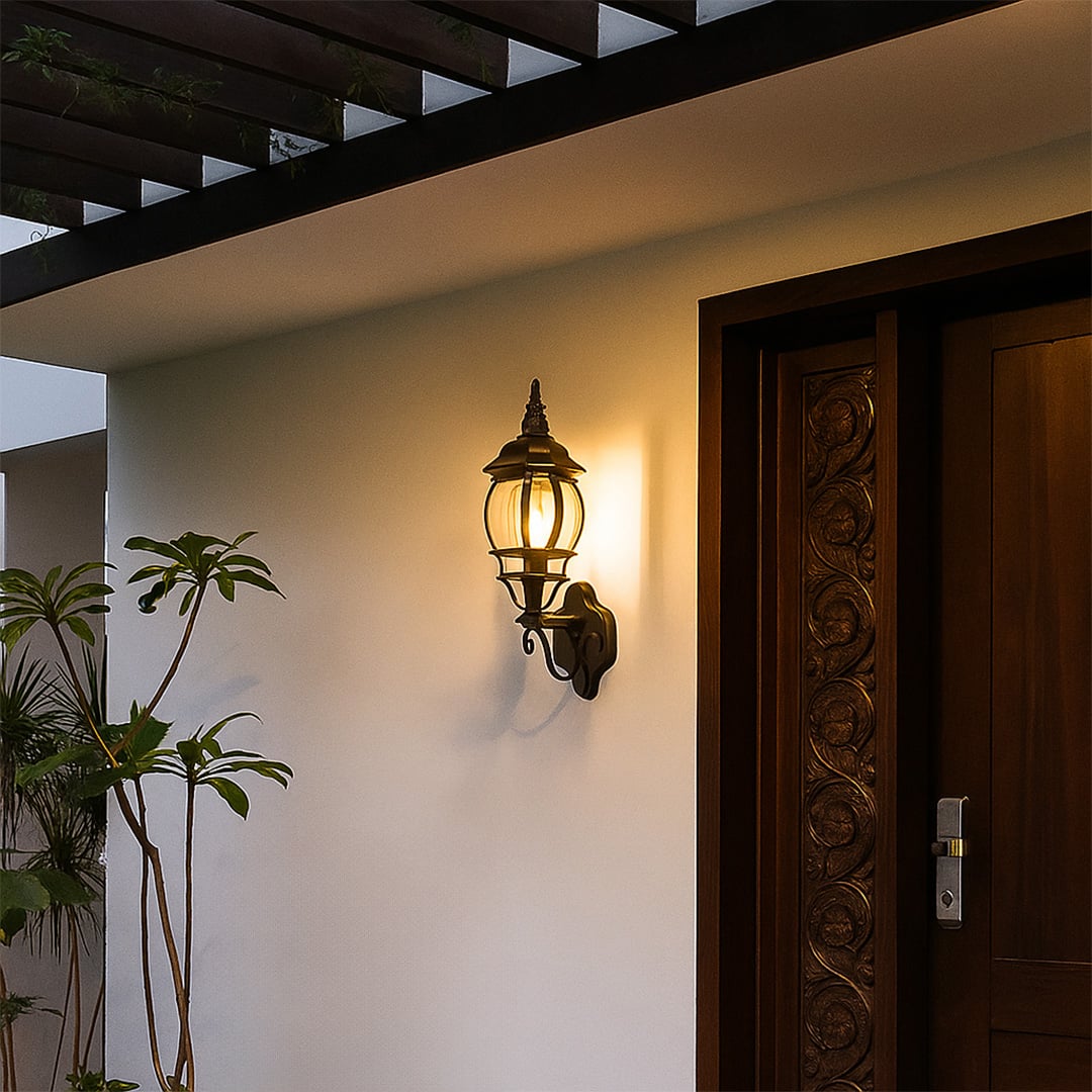 Black upward outdoor wall lantern with curved glass and scroll bracket creating vintage coach style outdoor porch lighting.