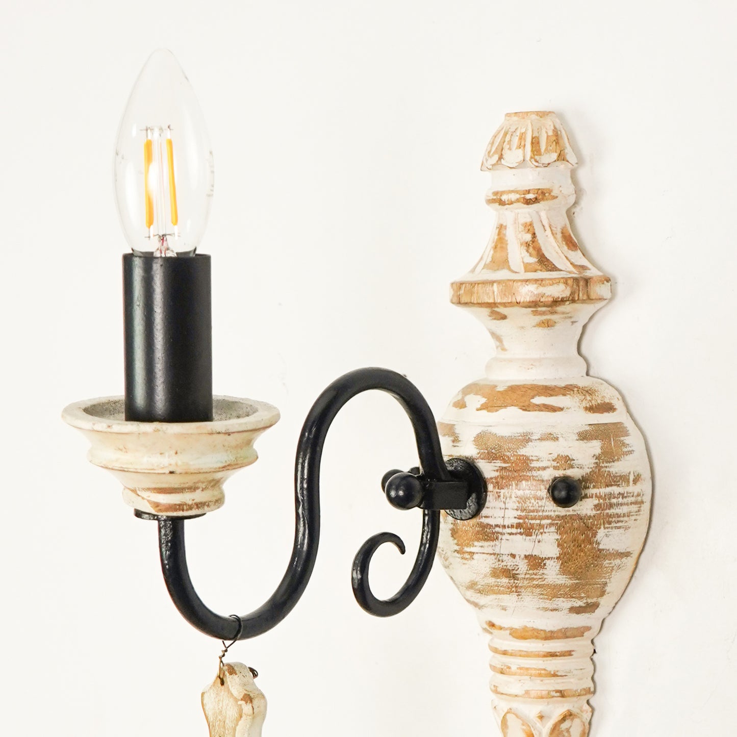 Closeup image of industry favorite wood and iron single light wall sconce for elegant rustic living room interior styling.