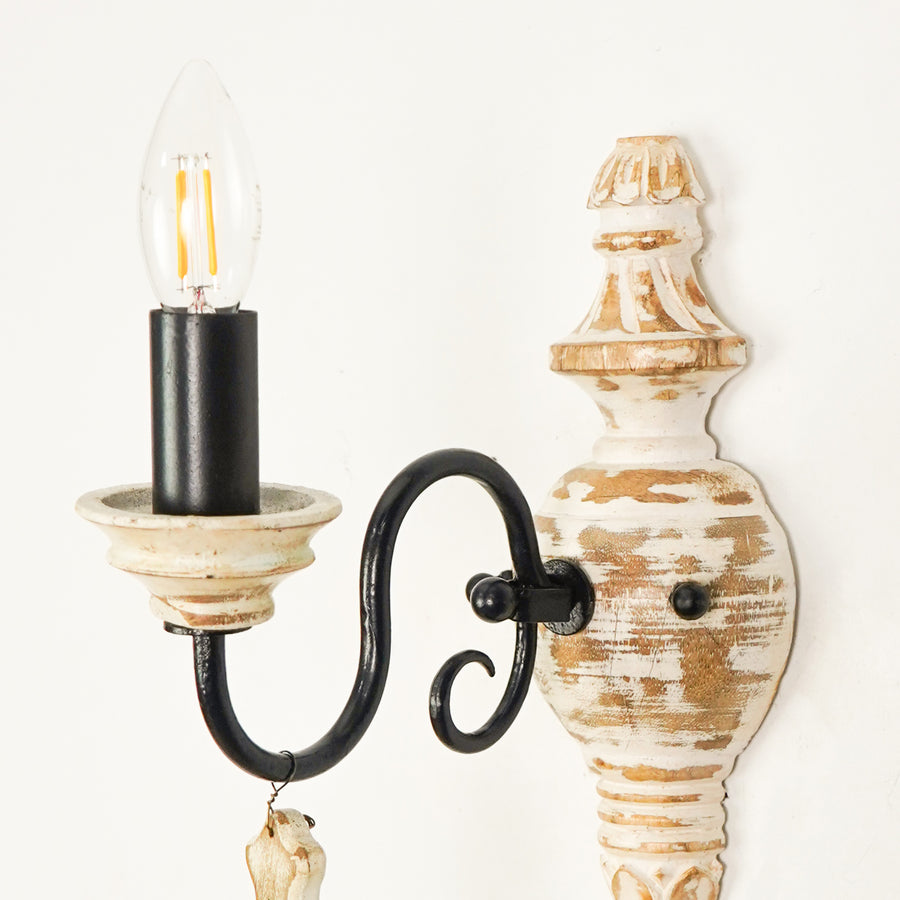 Closeup image of industry favorite wood and iron single light wall sconce for elegant rustic living room interior styling.