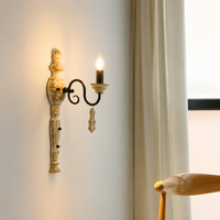 Lifestyle image of industry favorite wood and iron single light wall sconce for elegant rustic living room decor styling.
