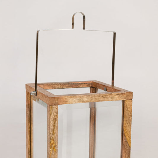 Closeup of wooden frame lantern showing natural wood grain clear glass panels and sturdy handcrafted decorative structure.