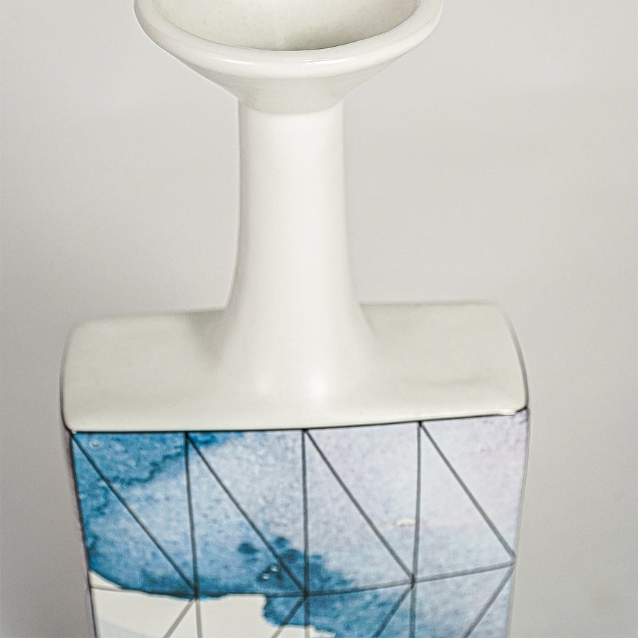 Closeup image of white ceramic bottle vase with abstract blue artwork for elegant console table decor styling.