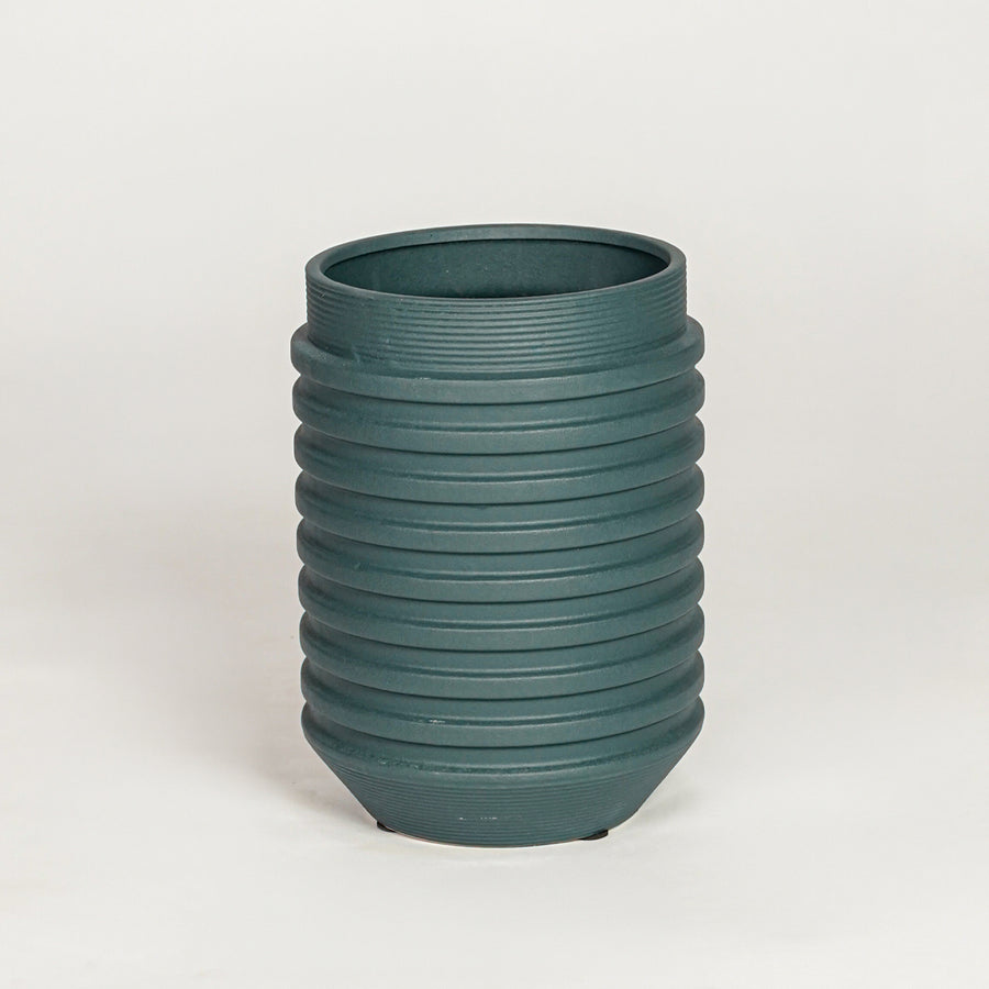 Matte dark green ribbed cylindrical vase for minimalist home decor and contemporary interior table styling needs.
