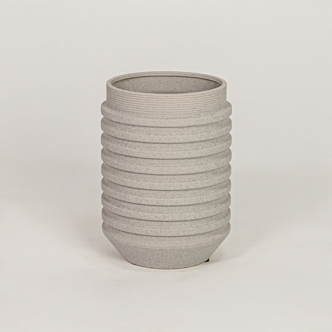 Textured grey ribbed cylindrical vase for minimalist home decor and contemporary interior table styling accents.