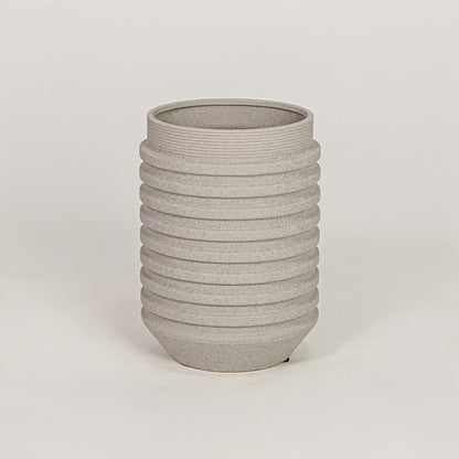 Textured grey ribbed cylindrical vase for minimalist home decor and contemporary interior table styling accents.