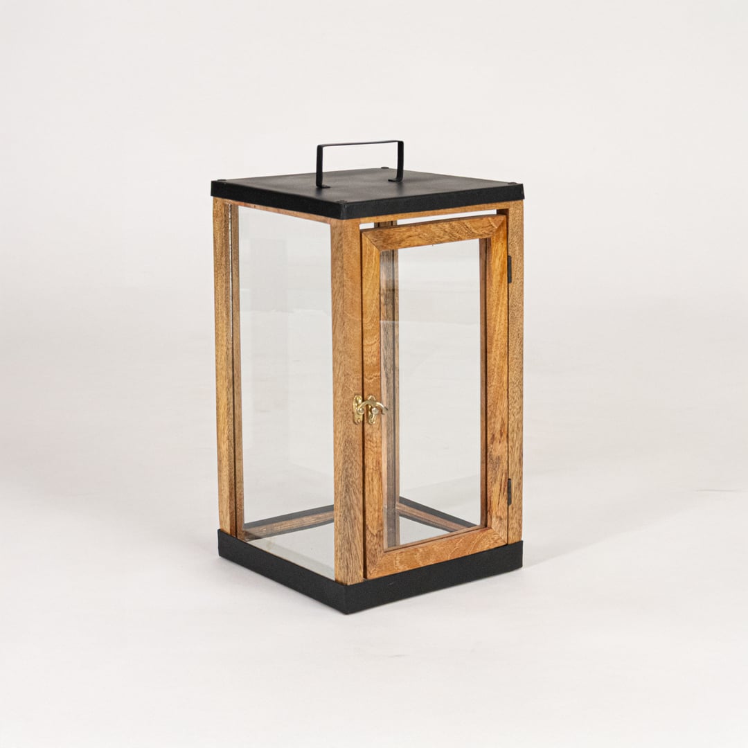 Modern wooden and black metal lantern with glass panels on white background suitable for living room shelf Decor.