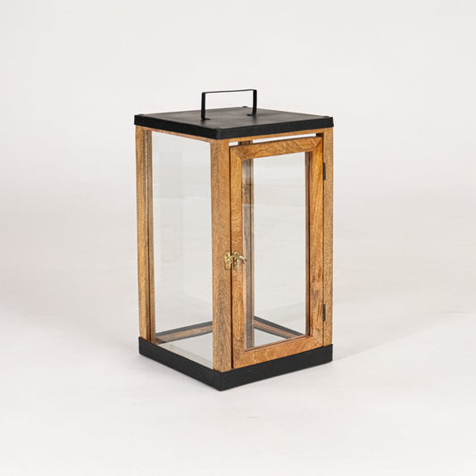 Modern wooden and black metal lantern with glass panels on white background suitable for living room shelf Decor.