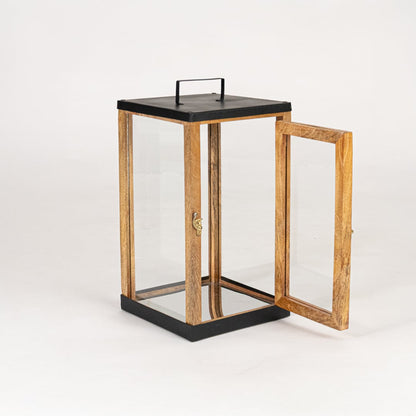 Decorative wooden lantern with black metal accents and glass panels on white background for tabletop and floor Decor.