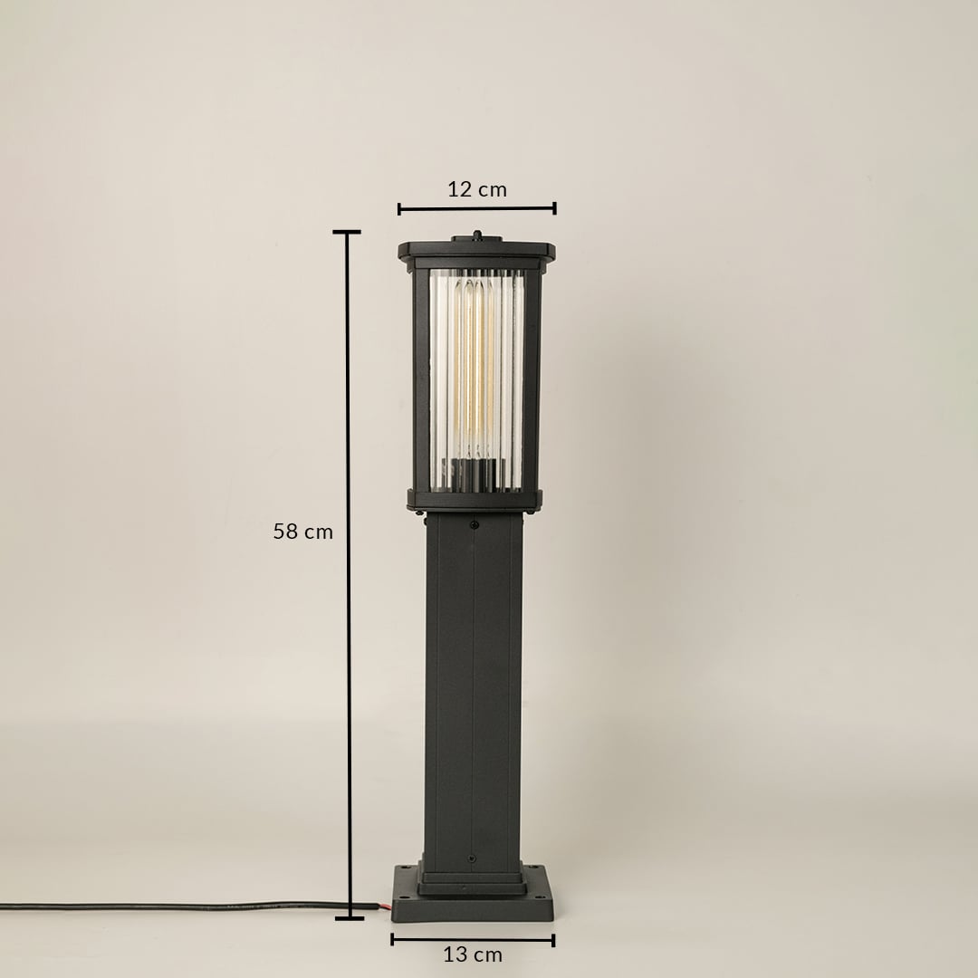 Black outdoor bollard light with ribbed glass shown with 58 cm height 12 cm width and 13 cm base providing accurate measurements for landscape placement.