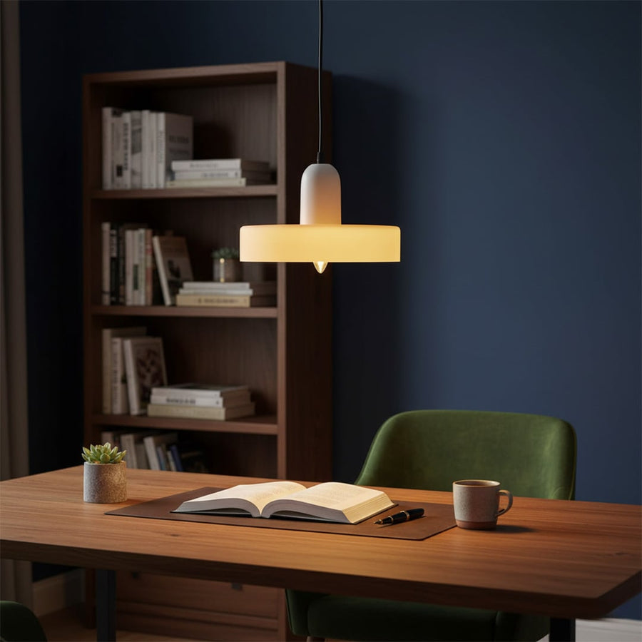 Table lamp with metal base and fabric shade placed on study desk adding warm focused lighting and refined style to home office decor.