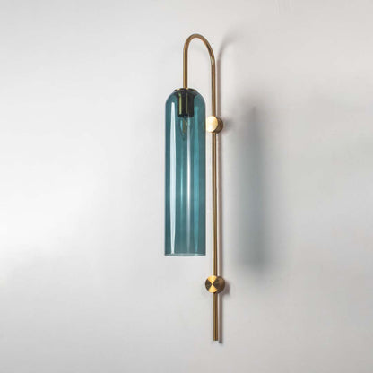 Teal glass and gold metal wall light with bulb off on a clean white background highlighting its slim cylinder shade and minimal contemporary form.