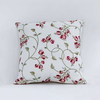 White cushion cover with red floral vine print on soft fabric designed for sofa chair and bed home decor styling.