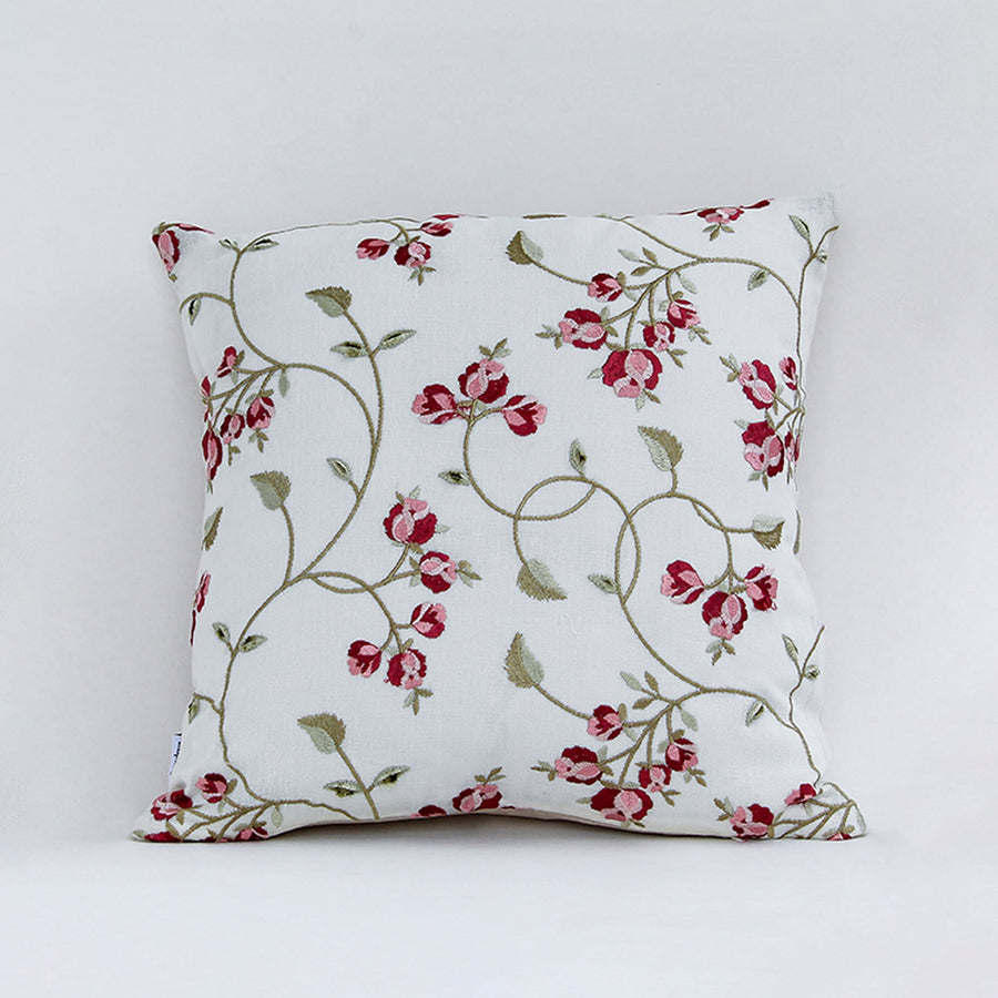 White cushion cover with red floral vine print on soft fabric designed for sofa chair and bed home decor styling.