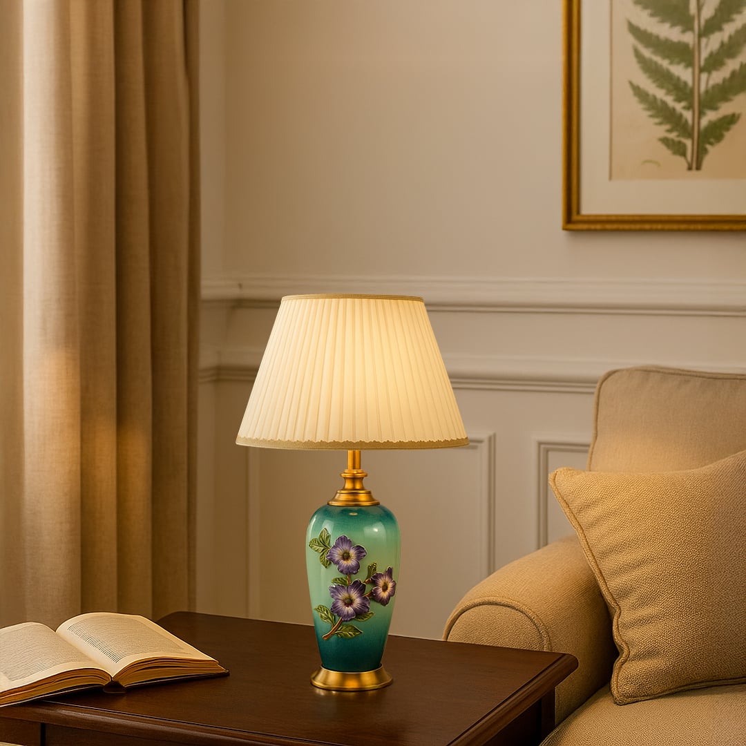 White shade floral ceramic table lamp on wooden side table with light on beside beige sofa for colorful decorative décor.
