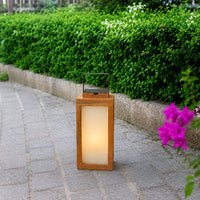 Modern copper metal outdoor lantern with frosted glass panels creating warm pathway lighting for stylish garden spaces.