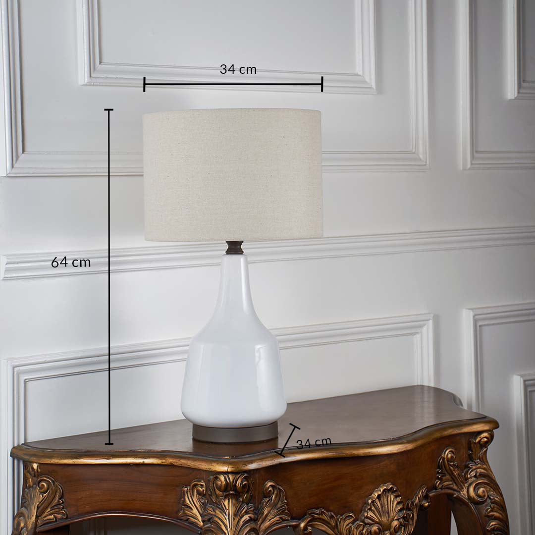 White ceramic table lamp with fabric shade shown on a wooden table with marked dimensions including 64 cm height and 34 cm shade width against a white background.