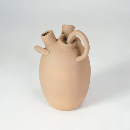 Beige sculptural ceramic vase for modern shelf placement and elegant indoor home decor styling accent piece.