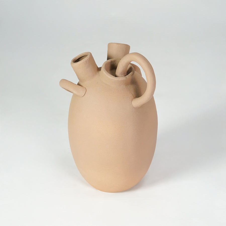Beige sculptural ceramic vase for modern shelf placement and elegant indoor home decor styling accent piece.