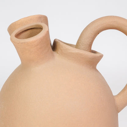 Closeup image of beige ceramic pitcher vase for modern console table decor with earthy matte finish styling.