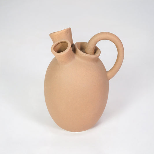 Beige ceramic vase with artistic handles for modern shelf placement and elegant indoor decor styling accent.