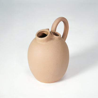 Beige ceramic vase with handle for stylish console table placement and contemporary indoor decor styling accent.