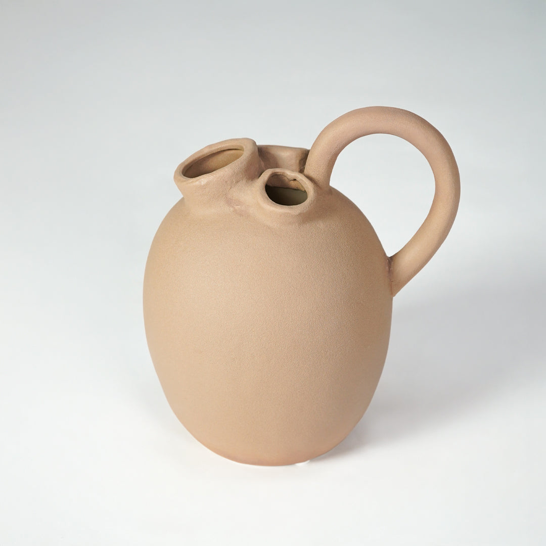 Minimalist beige ceramic vase for elegant coffee table placement and modern living room decor styling piece.