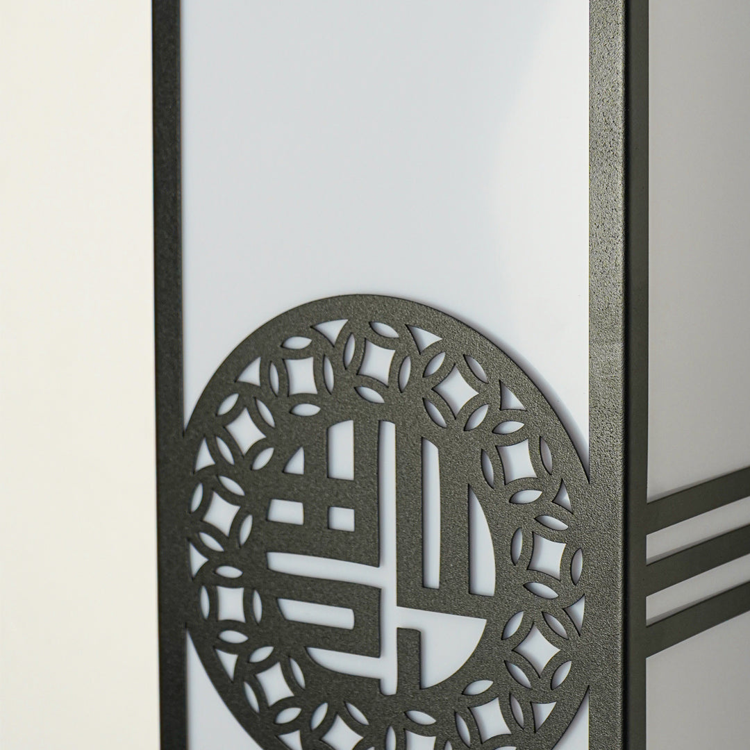 Close view of decorative outdoor wall light with geometric metal pattern and glass panels showcasing modern exterior lighting design.