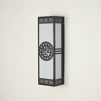 Modern black exterior wall light with geometric design and glass enclosure on neutral background perfect for outdoor home decor lighting.

