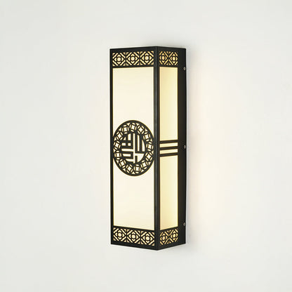 Decorative outdoor wall lantern with patterned metal frame and glass panels mounted on exterior wall ideal for porch or entry lighting.