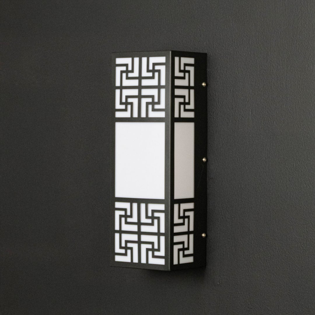 Contemporary wall light with black frame and frosted glass panel displayed off against dark background surface.