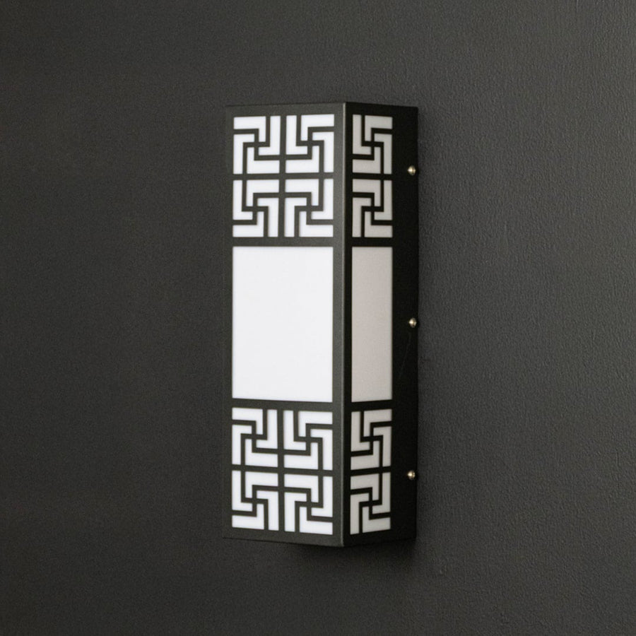 Contemporary wall light with black frame and frosted glass panel displayed off against dark background surface.