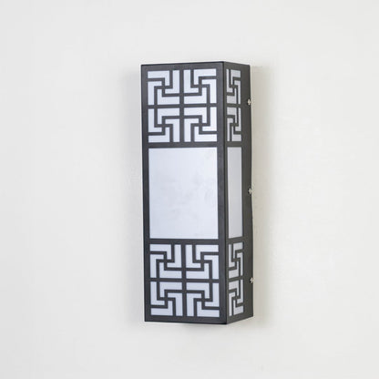 Stylish wall light with black metal body and frosted glass shade displayed off on plain white background.