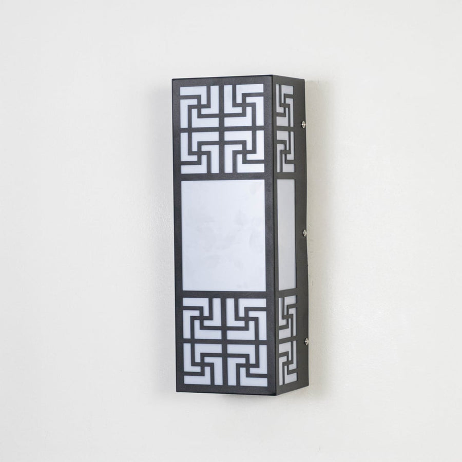 Stylish wall light with black metal body and frosted glass shade displayed off on plain white background.