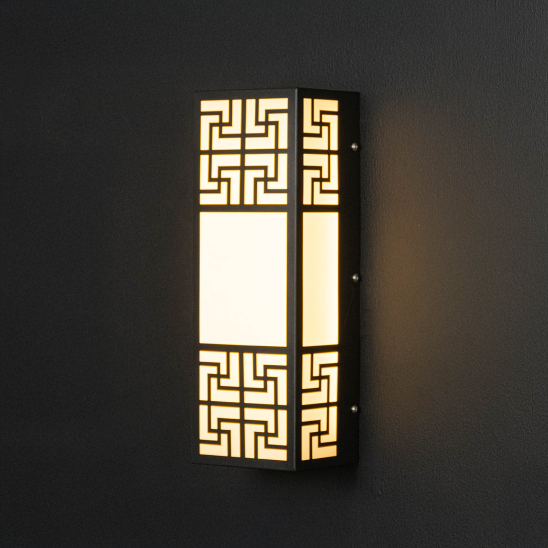 Black geometric wall light glowing warmly through frosted glass adding sophistication to modern wall spaces.