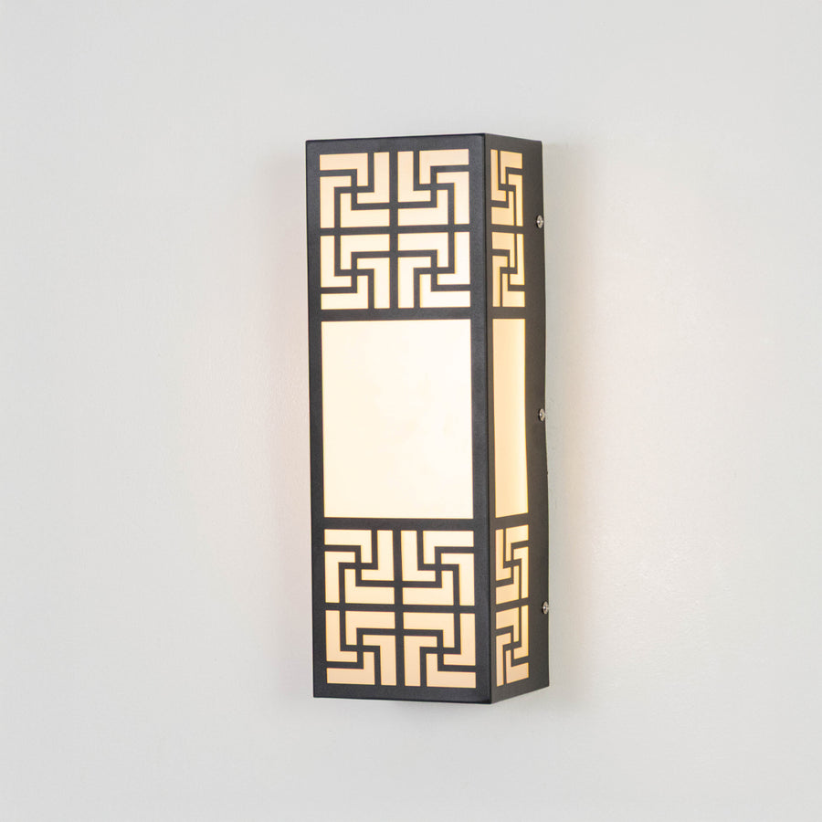 Black metal wall light on white background with geometric pattern and frosted glass for luxury decor.