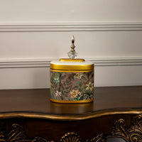 Decorative jar with intricate floral artwork and gold detailing on a white background.