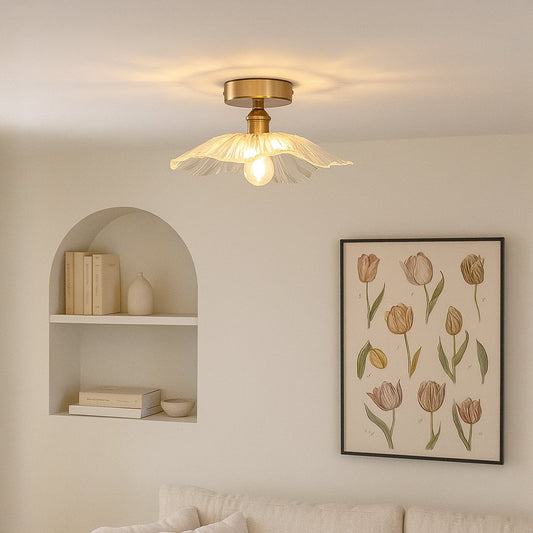 Modern ceiling light with brushed gold base and flower shaped glass shade styled in living room for elegant home lighting.