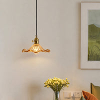 Amber textured glass pendant light above side table adding warm ambient lighting to a modern living room decor.