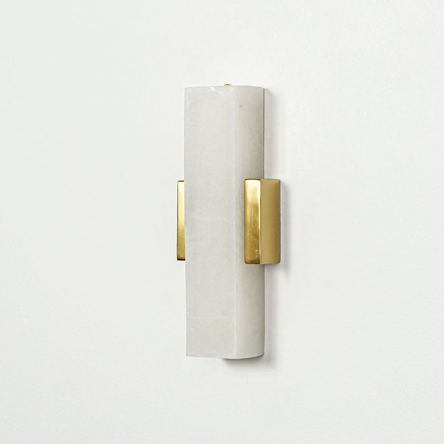 Gold wall light with vertical frosted glass tube mounted on neutral wall background ideal for modern bedroom or hallway lighting.