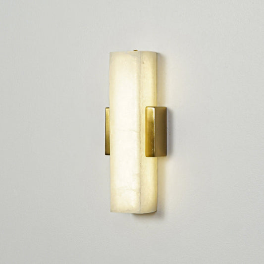 Gold wall sconce with cylindrical frosted glass shade mounted on neutral wall background perfect for modern bedroom or hallway lighting.

