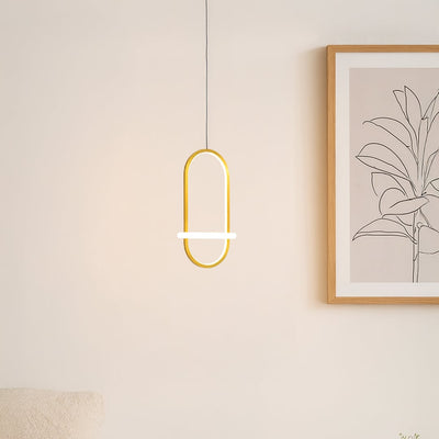 Gold metal LED wall light with warm glow enhancing bedroom decor above the side table and artwork.