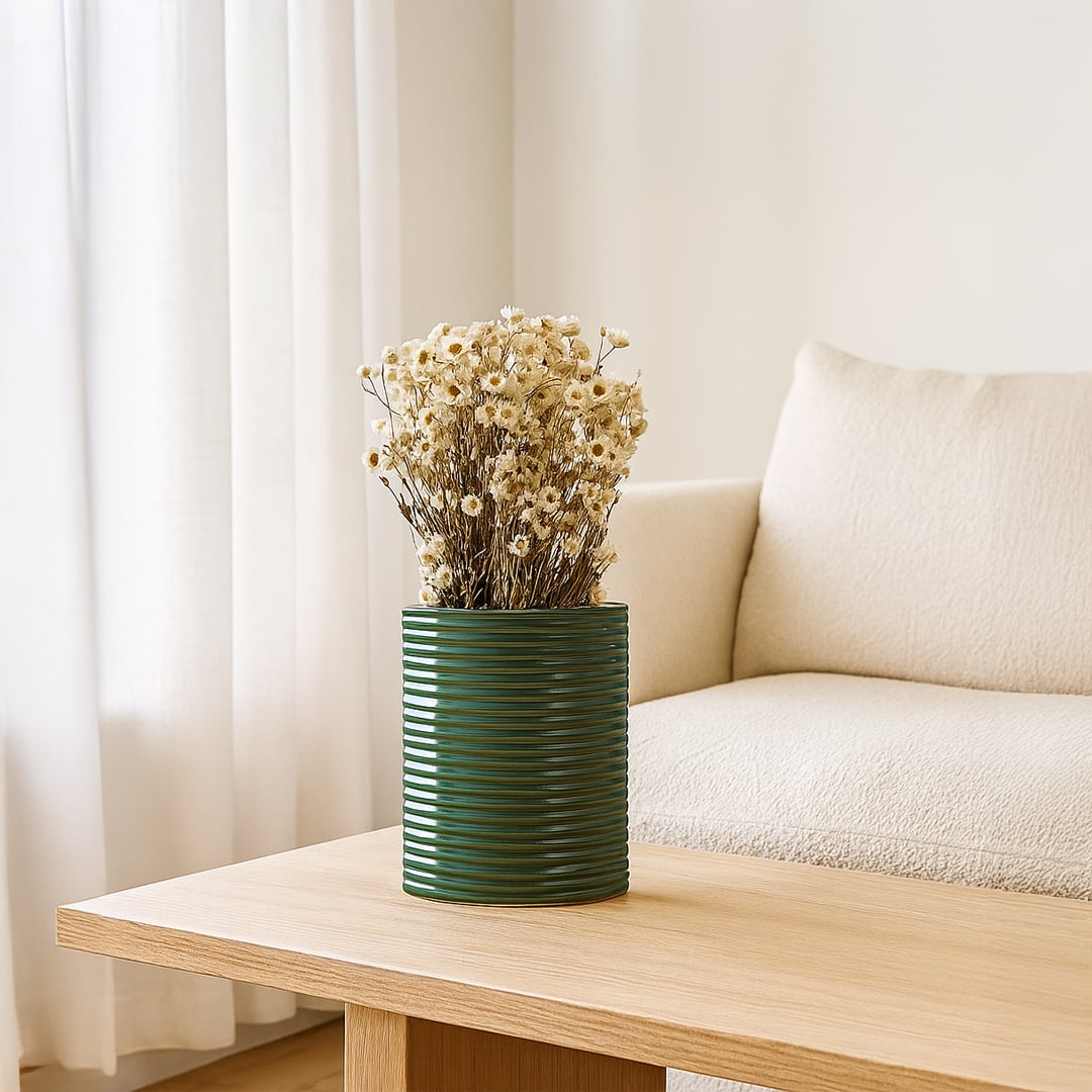 Dark green ribbed ceramic planter styled in a modern interior perfect for consoles shelves and elegant contemporary home decor.