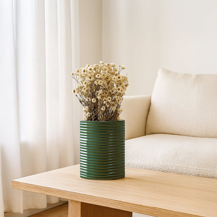 Dark green ribbed ceramic planter styled in a modern interior perfect for consoles shelves and elegant contemporary home decor.