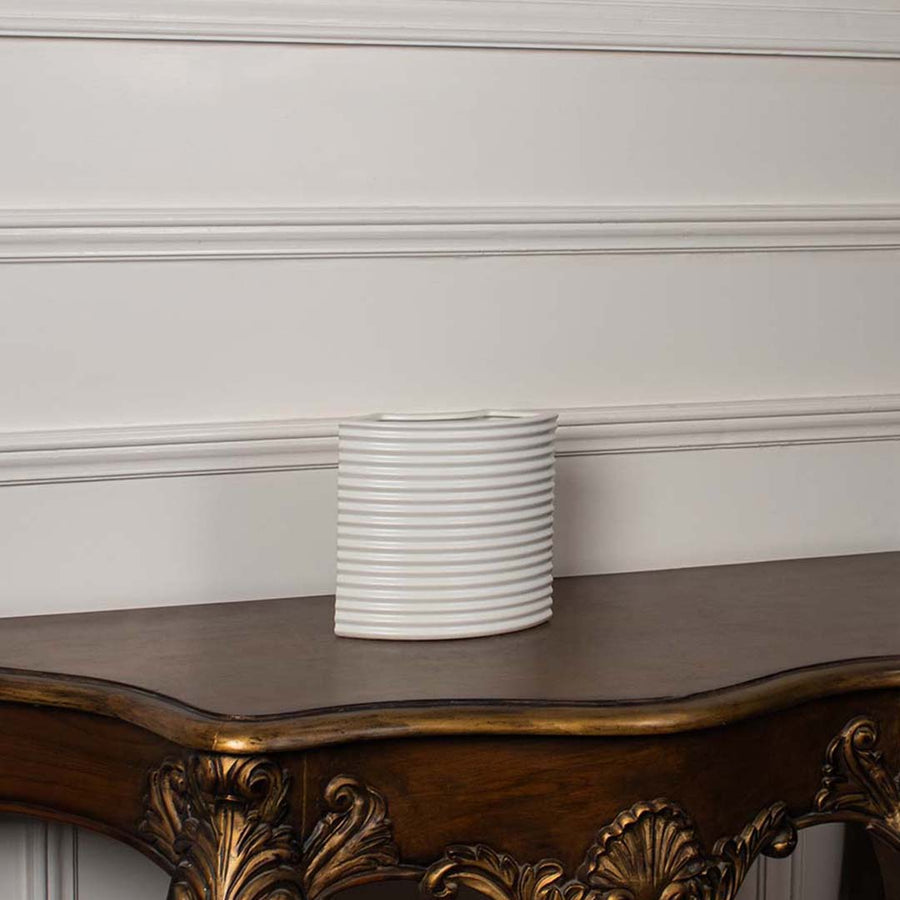 White ribbed ceramic planter displayed on a clean white background ideal for sleek home decor and tabletop styling.