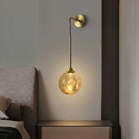 Closeup of gold metal crystal wall light for luxury bedroom hallway and elegant modern decor styling spaces.