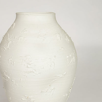 White ceramic textured decorative vase with artistic sculpted surface perfect for elegant dried floral display and modern interior decor.