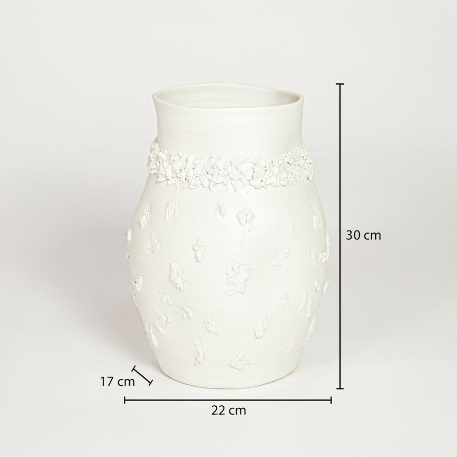 White ceramic embossed decorative vase measuring 30 cm height 22 cm width and 17 cm depth ideal for elegant home decor placement.