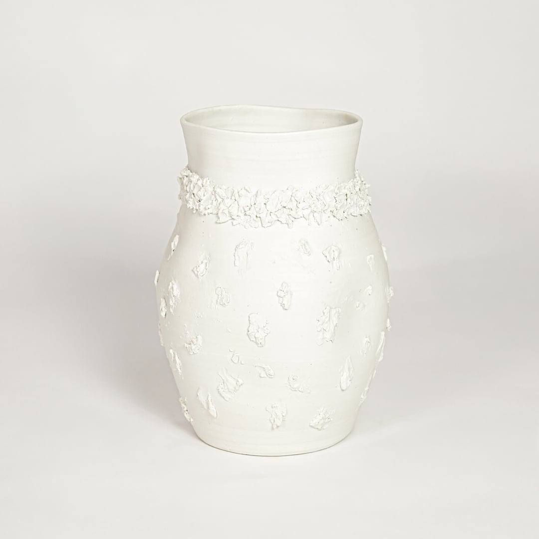 Classic white ceramic flower vase with ornamental texture perfect for entryway table living room or dining decor display.