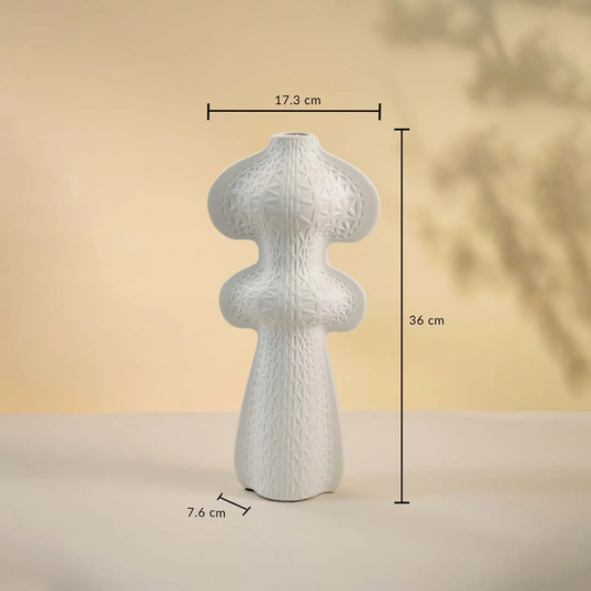 White ceramic vase displayed on a neutral background measuring 36 cm in height 17.3 cm in width and 7.6 cm in base diameter.
