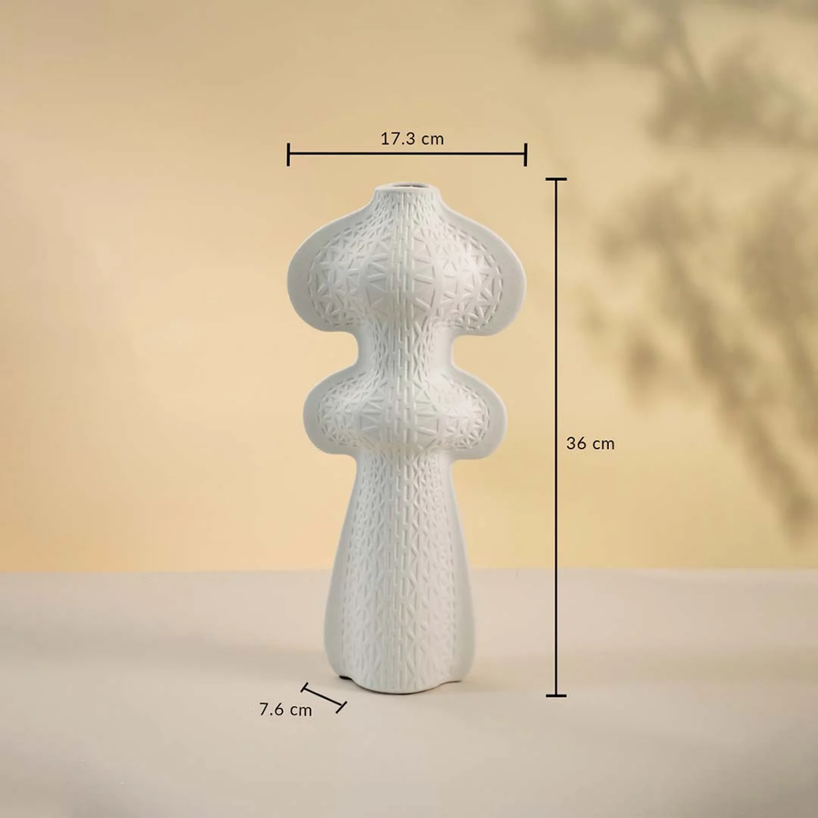 White ceramic vase displayed on a neutral background measuring 36 cm in height 17.3 cm in width and 7.6 cm in base diameter.